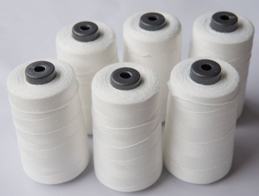 Spools of tailor made high tech Low Melt Yarn supplied by SageZander - Yarn Supplier UK